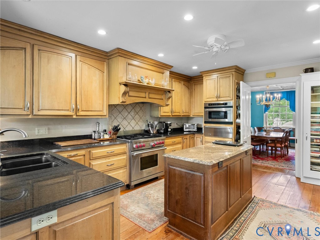 2625 Old Tavern Road Powhatan, VA 23139 - Photo 28 of 100 a kitchen with stainless steel appliances granite countertop a stove a sink and a microwave