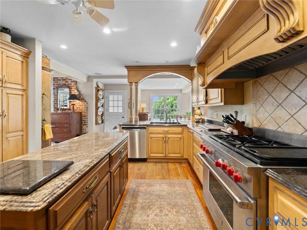 2625 Old Tavern Road Powhatan, VA 23139 - Photo 32 of 100 a kitchen with stainless steel appliances granite countertop a stove a sink and a refrigerator