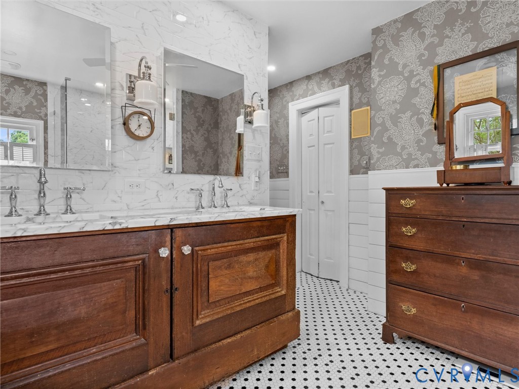 2625 Old Tavern Road Powhatan, VA 23139 - Photo 39 of 100 a spacious bathroom with a granite countertop sink a mirror and shower