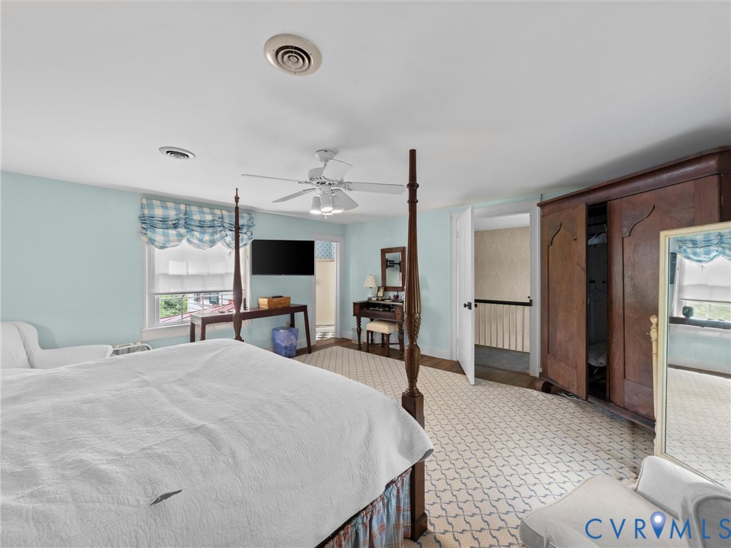2625 Old Tavern Road Powhatan, VA 23139 - Photo 55 of 100 a large bedroom with a bed and a flat screen tv
