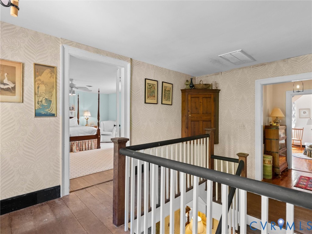 2625 Old Tavern Road Powhatan, VA 23139 - Photo 58 of 100 a view of a hallway to a livingroom with wooden floor and windows