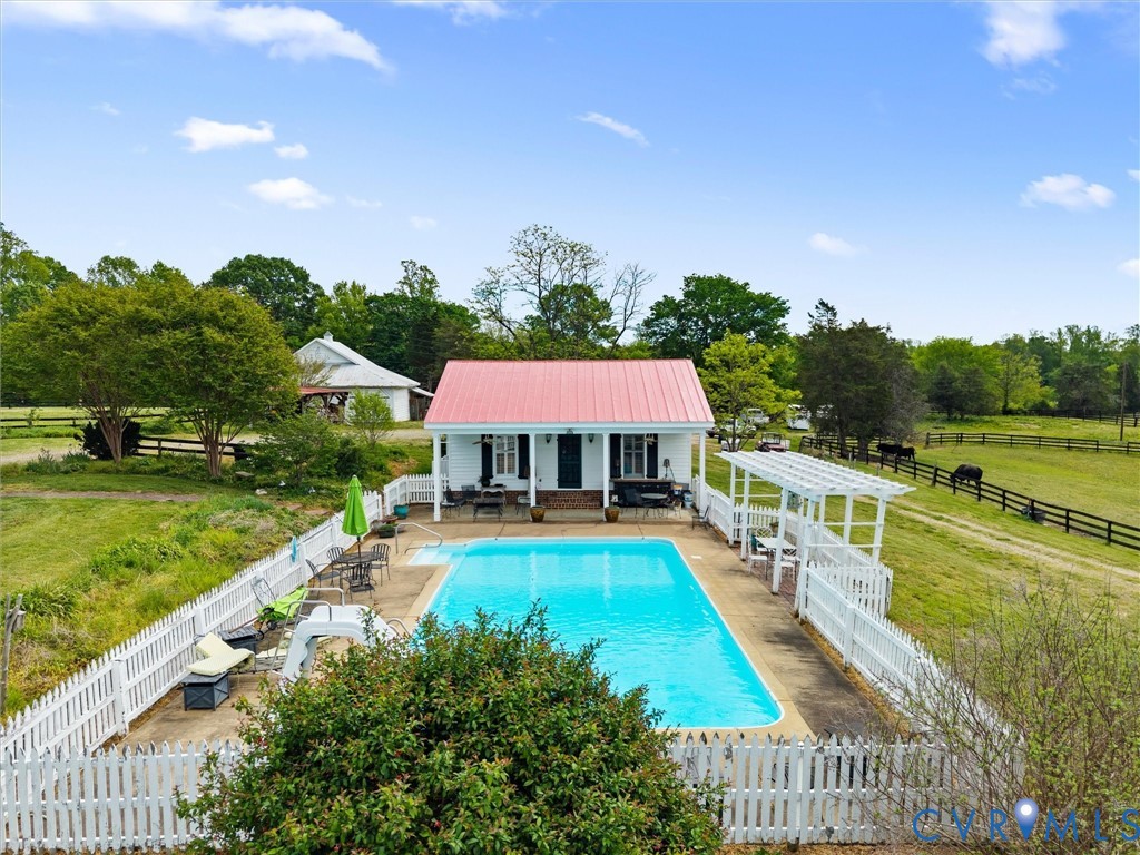 2625 Old Tavern Road Powhatan, VA 23139 - Photo 65 of 100 a view of a swimming pool and lounge chairs in back yard of the house