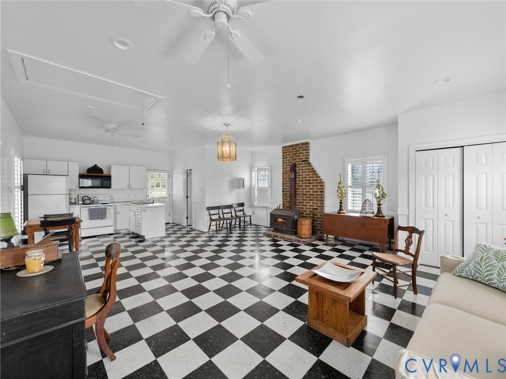 2625 Old Tavern Road Powhatan, VA 23139 - Photo 69 of 100 a living room with a black white checkered floor with couches chair and view kitchen