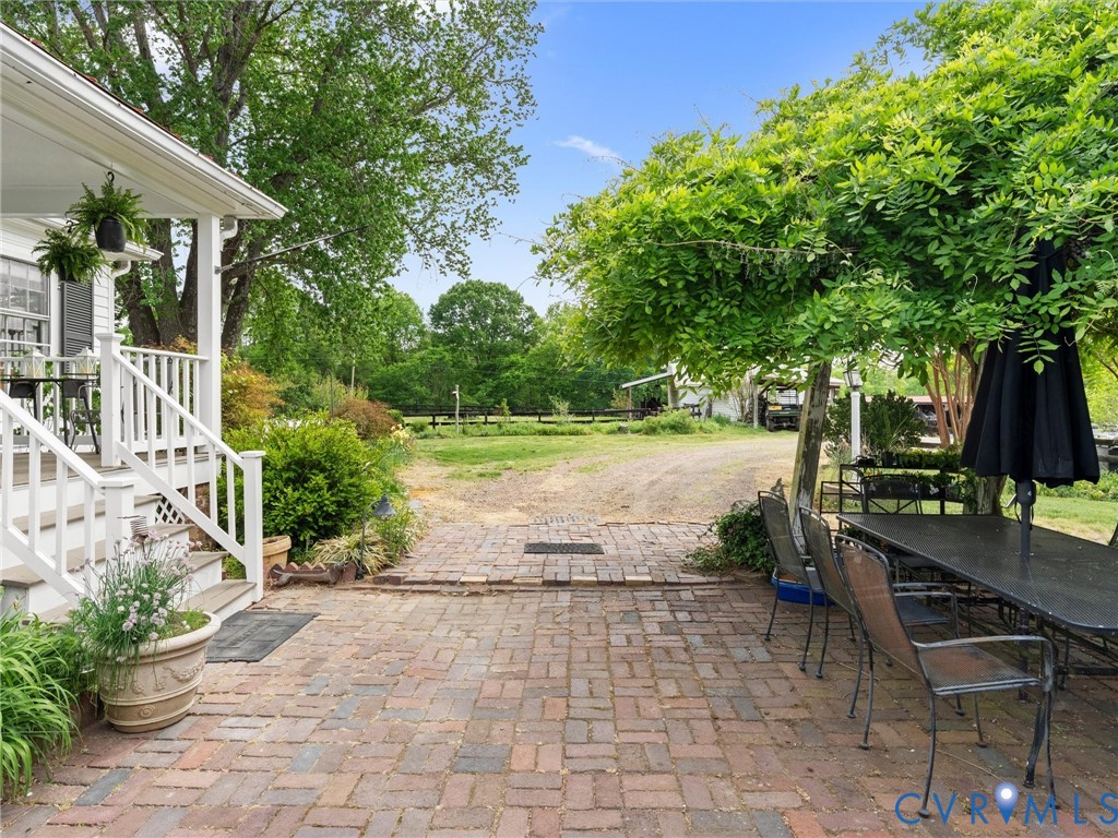 2625 Old Tavern Road Powhatan, VA 23139 - Photo 89 of 100 a view of a patio with table and chairs potted plants and large tree