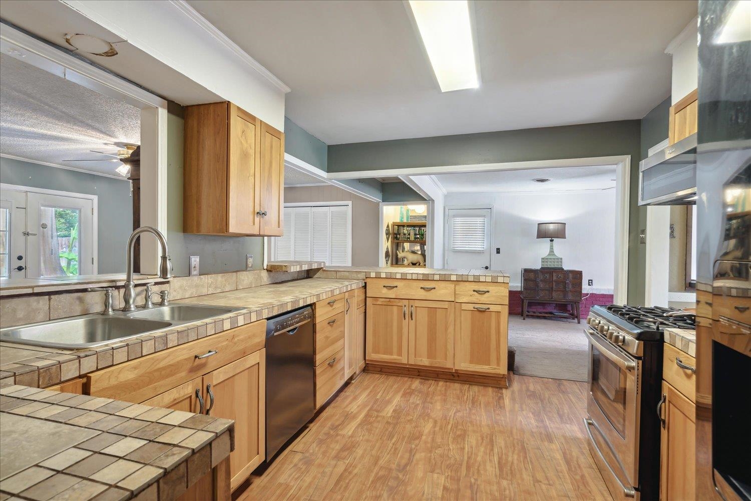 4608 Boyce Road Memphis, TN 38117 - Photo 11 of 30 a large kitchen with a lot of counter space and wooden floor