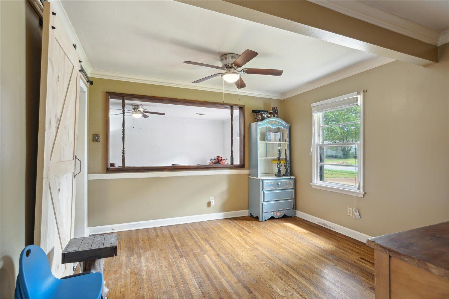 4608 Boyce Road Memphis, TN 38117 - Photo 16 of 30 a view of empty room with wooden floor and fan