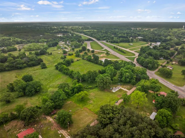 an aerial view of residential houses with outdoor space and swimming pool