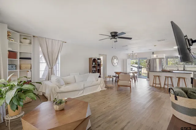 a living room with furniture and a wooden floor