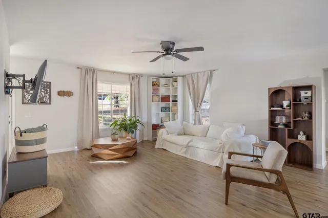 a living room with furniture and wooden floor