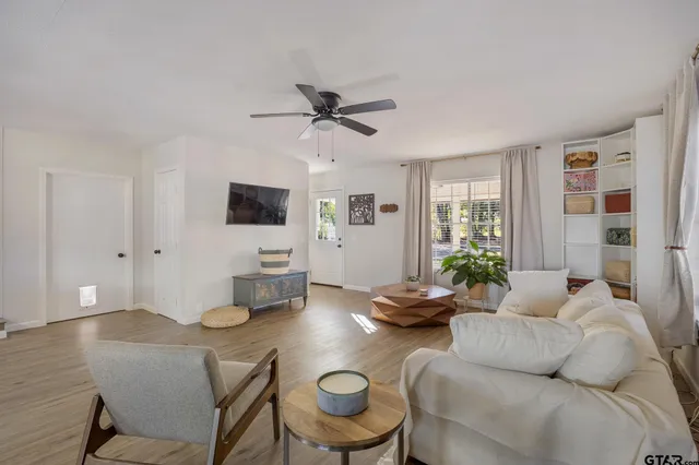 a living room with furniture and a flat screen tv