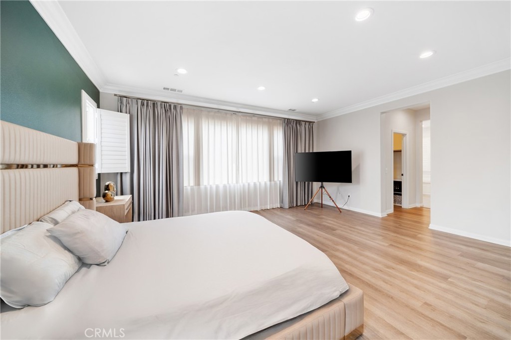 323 La Ventana Drive Brea, CA 92823 - Photo 18 of 47 a large bedroom with a bed and a flat screen tv