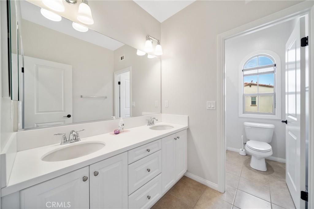 323 La Ventana Drive Brea, CA 92823 - Photo 26 of 47 a bathroom with a double vanity sink a toilet and a mirror