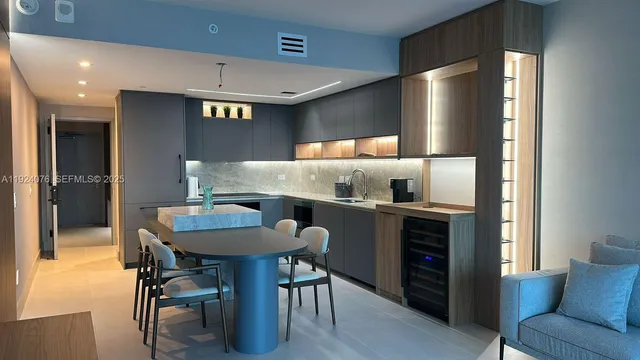 a kitchen with a table and chairs in it