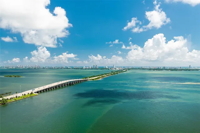 a spacious bedroom with a large bed and a large window