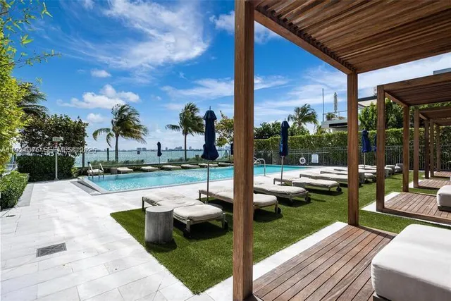 a view of yard from deck with patio