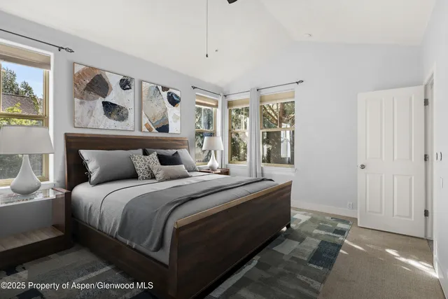 a bedroom with a large bed and a window