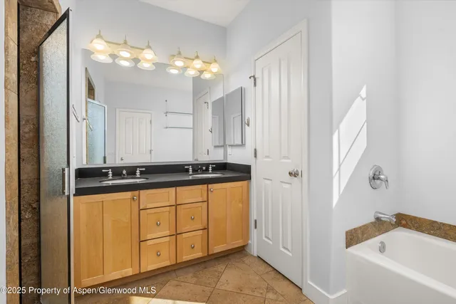 a bathroom with a sink a faucet a mirror and a bathtub