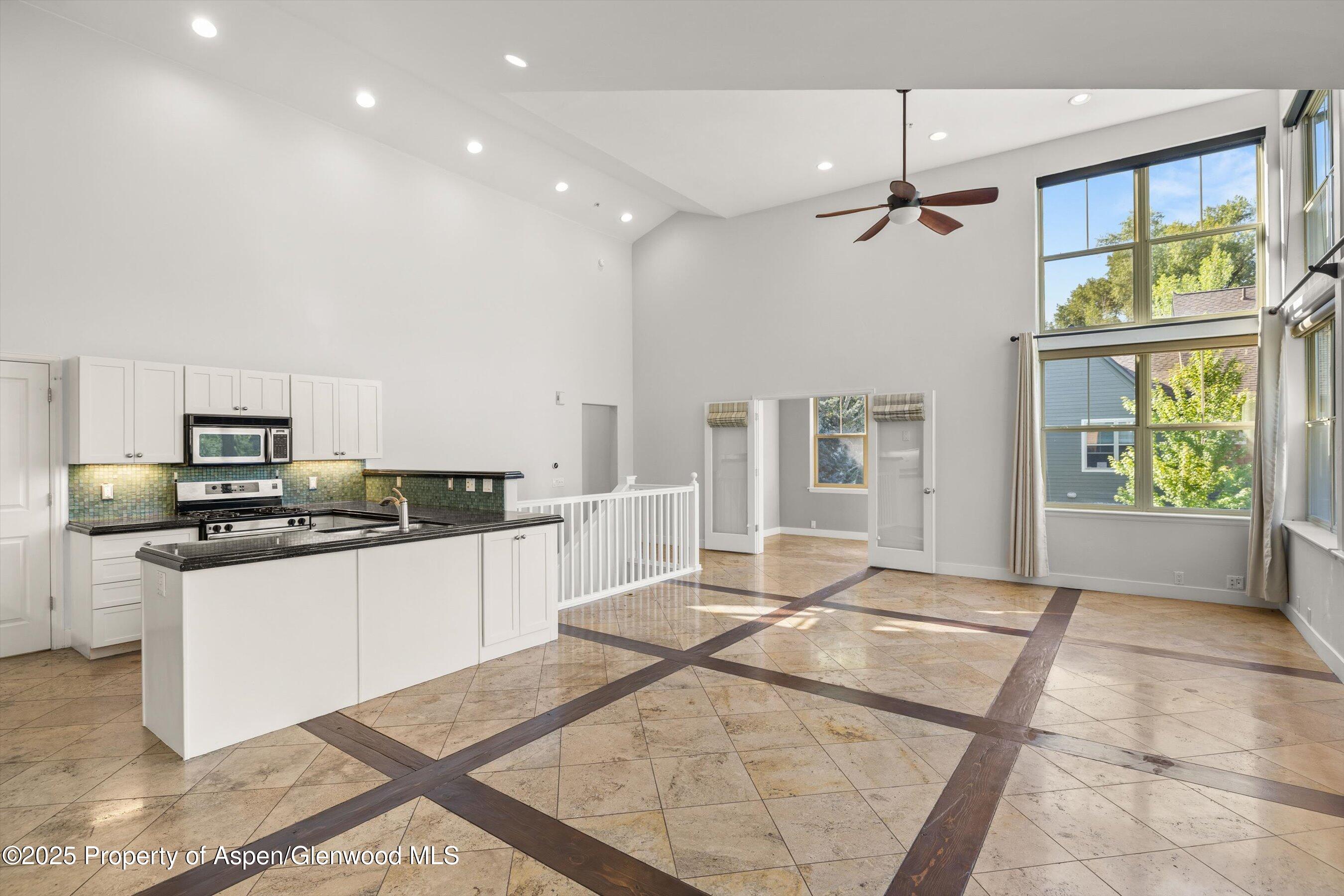 540 Evans Court Basalt, CO 81621 - Photo 2 of 24 a large kitchen with stainless steel appliances kitchen island granite countertop a refrigerator and a stove top oven