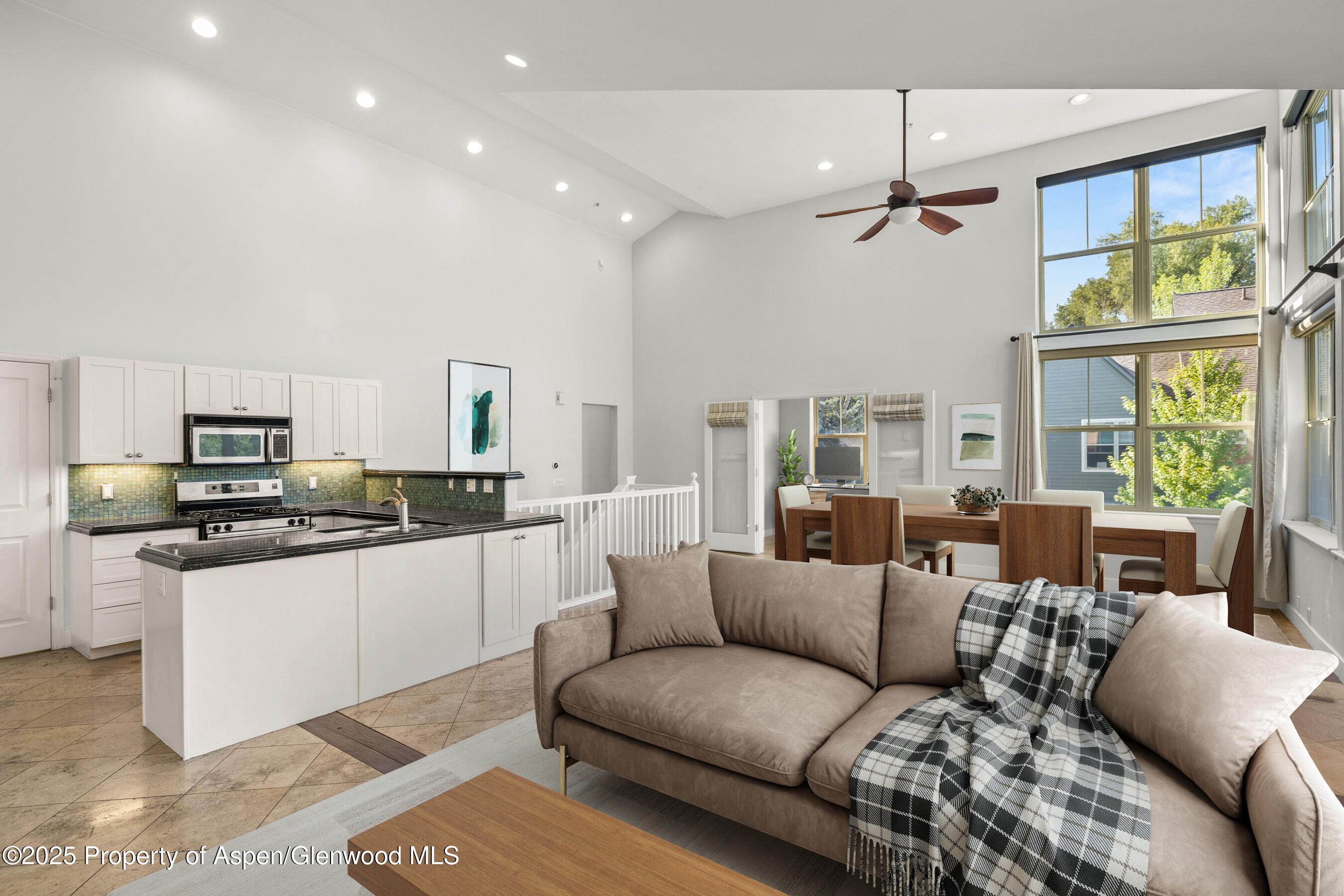 540 Evans Court Basalt, CO 81621 - Photo 3 of 24 a living room with stainless steel appliances kitchen island granite countertop a couch and a view of kitchen living room