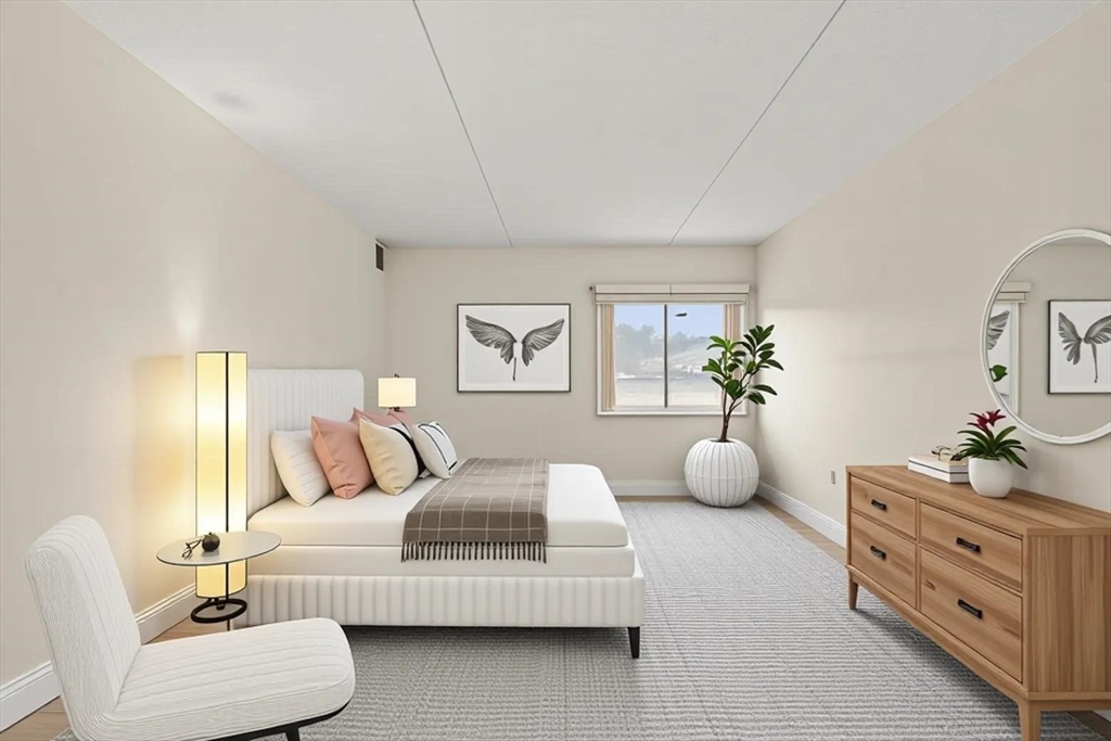 a bedroom with furniture and a potted plant