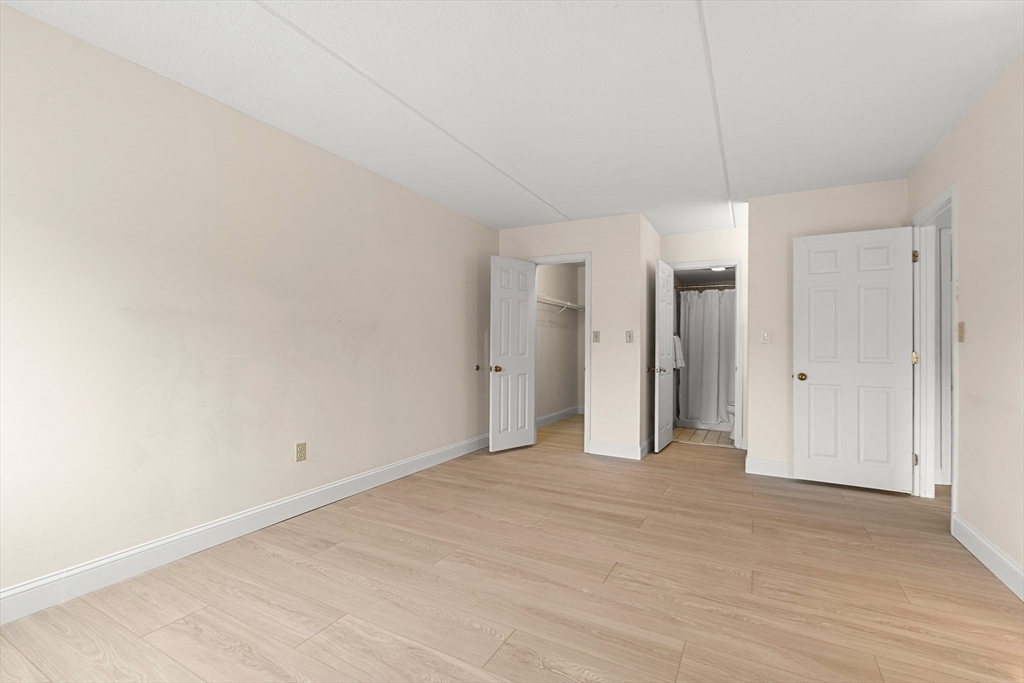 159 Main Street, Unit 11B Melrose, MA 02176 - Photo 18 of 33 a view of empty room with wooden floor
