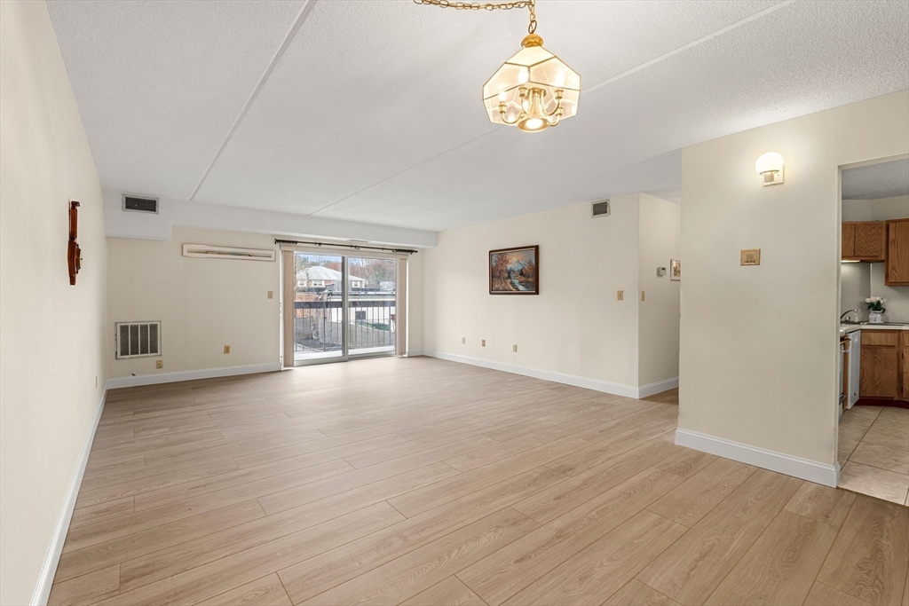 159 Main Street, Unit 11B Melrose, MA 02176 - Photo 25 of 33 a view of a livingroom with a furniture wooden floor and window