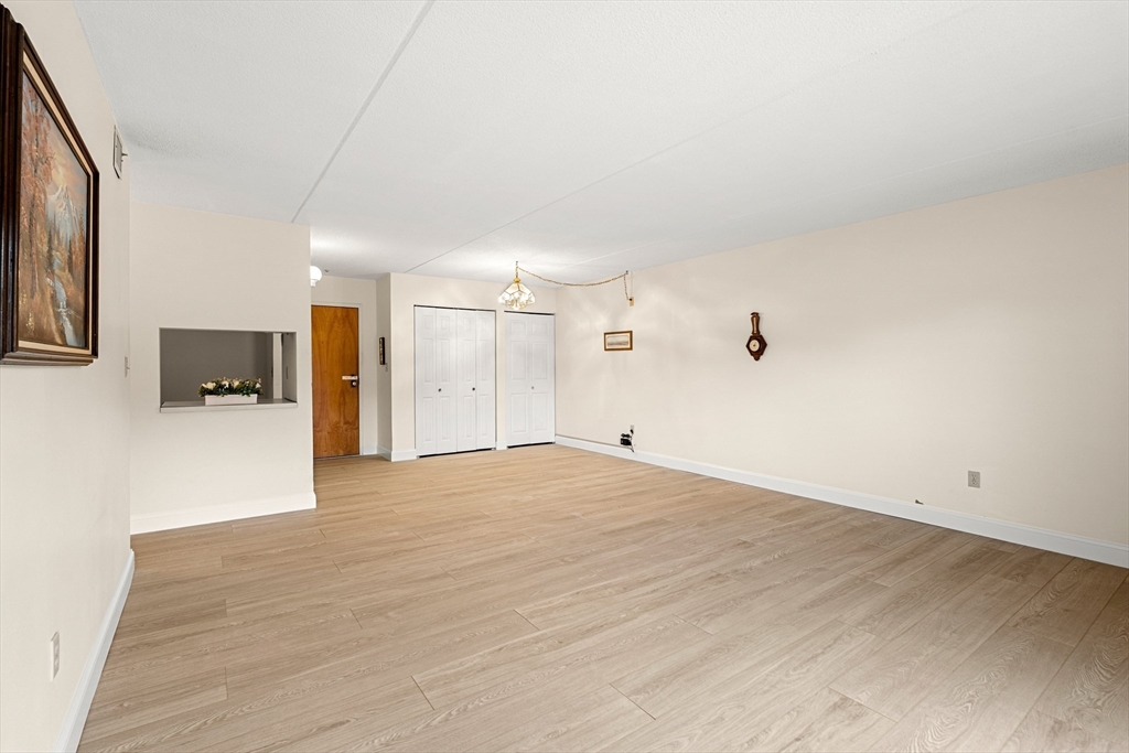 159 Main Street, Unit 11B Melrose, MA 02176 - Photo 26 of 33 a view of empty room with wooden floor