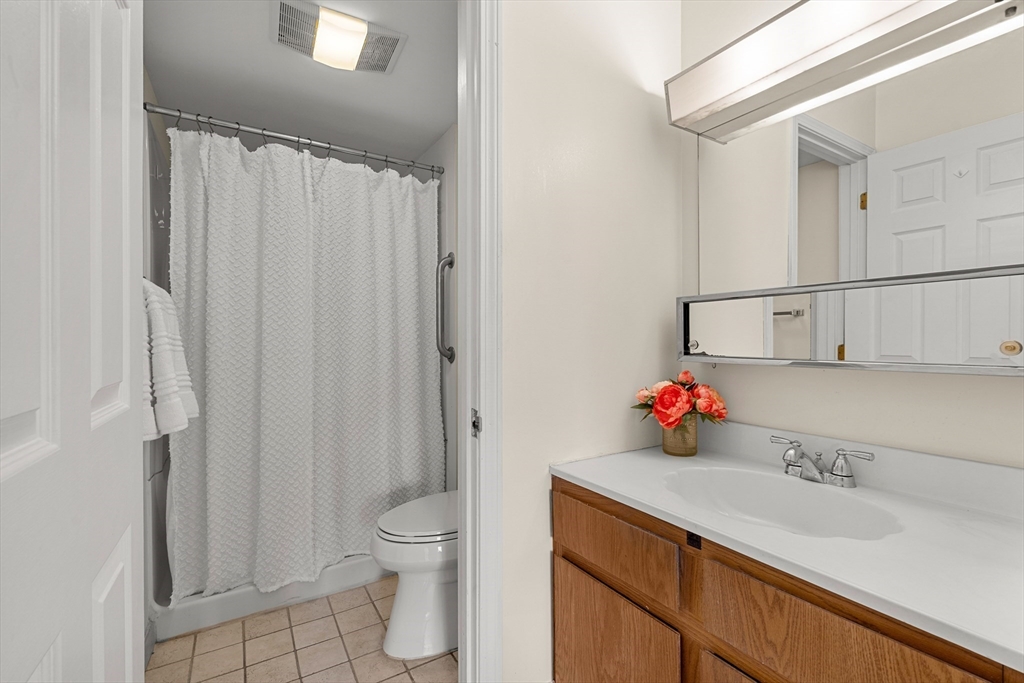 159 Main Street, Unit 11B Melrose, MA 02176 - Photo 3 of 33 a bathroom with a sink toilet vanity and shower