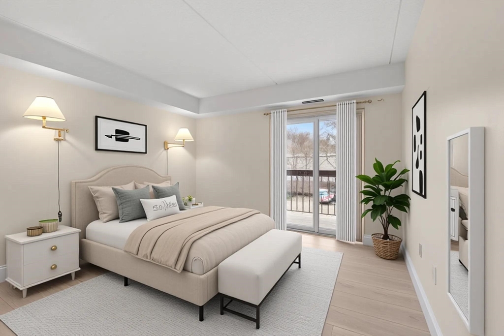 159 Main Street, Unit 11B Melrose, MA 02176 - Photo 8 of 33 a bedroom with a large bed and a potted plant