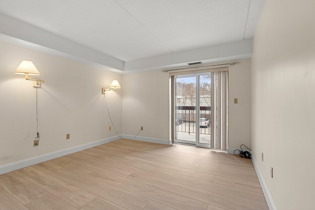 159 Main Street, Unit 11B Melrose, MA 02176 - Photo 9 of 33 wooden floor in an empty room with a window