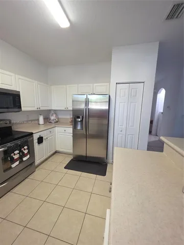 a view of a kitchen with a dining table and chairs