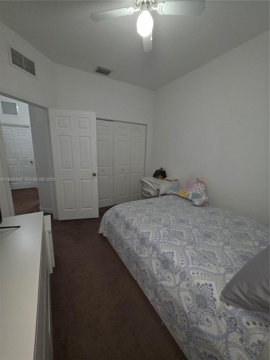 13236 Southwest 128th Street Miami, FL 33186 - Photo 25 of 41 a bedroom with a bed and a chandelier
