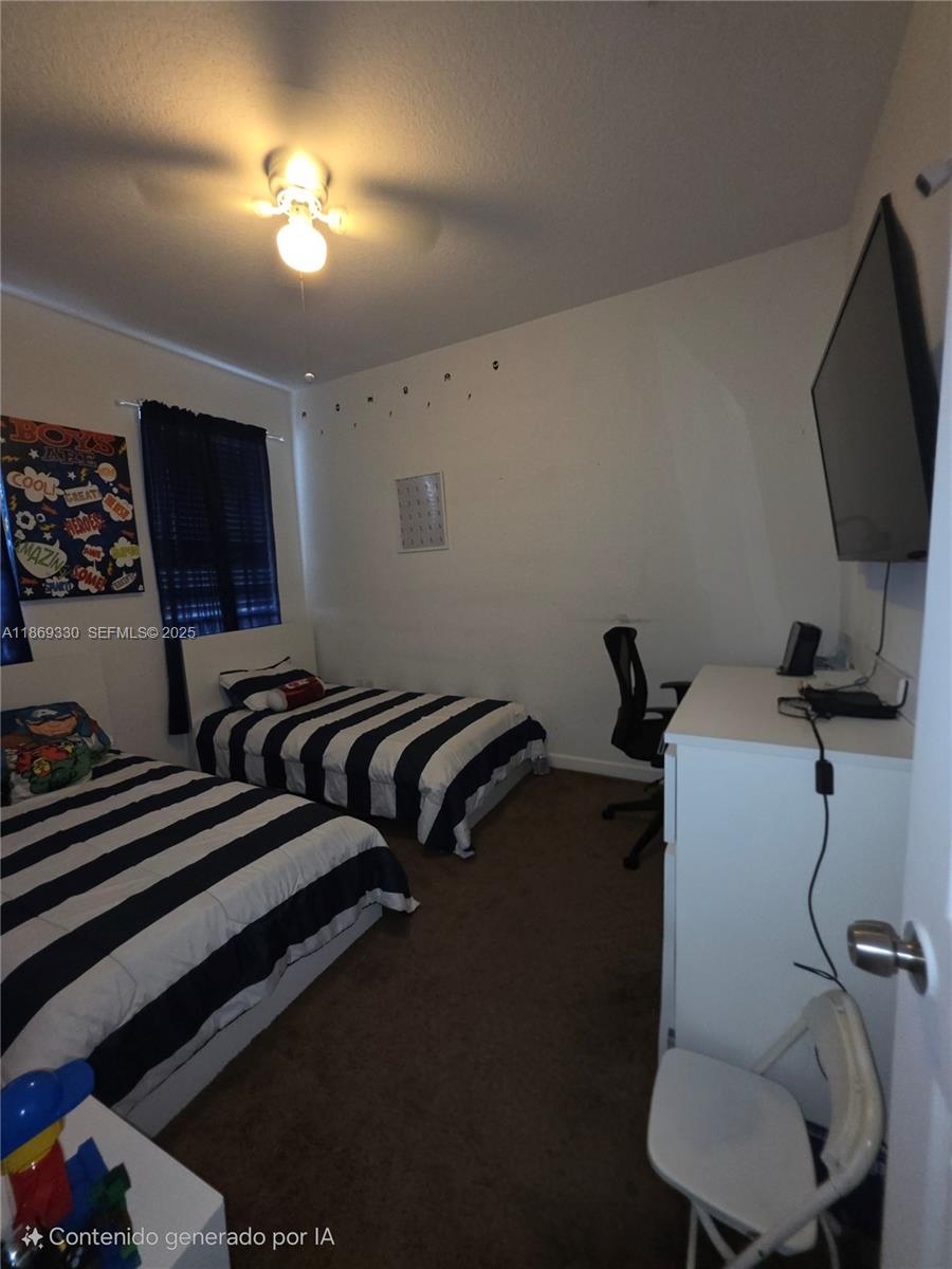 13236 Southwest 128th Street Miami, FL 33186 - Photo 27 of 41 a room with furniture and a flat screen tv