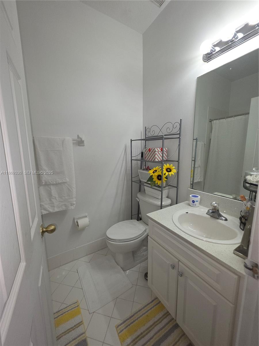 13236 Southwest 128th Street Miami, FL 33186 - Photo 31 of 41 a bathroom with a sink toilet and shower