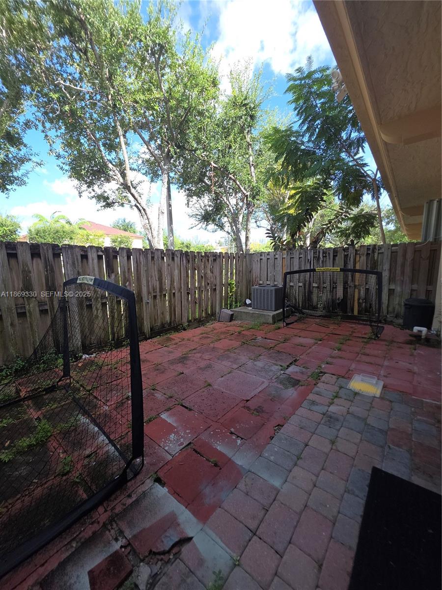 13236 Southwest 128th Street Miami, FL 33186 - Photo 33 of 41 a backyard of a house with lots of trees and entertaining space