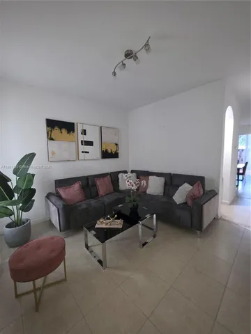 a bathroom with a granite countertop toilet and sink