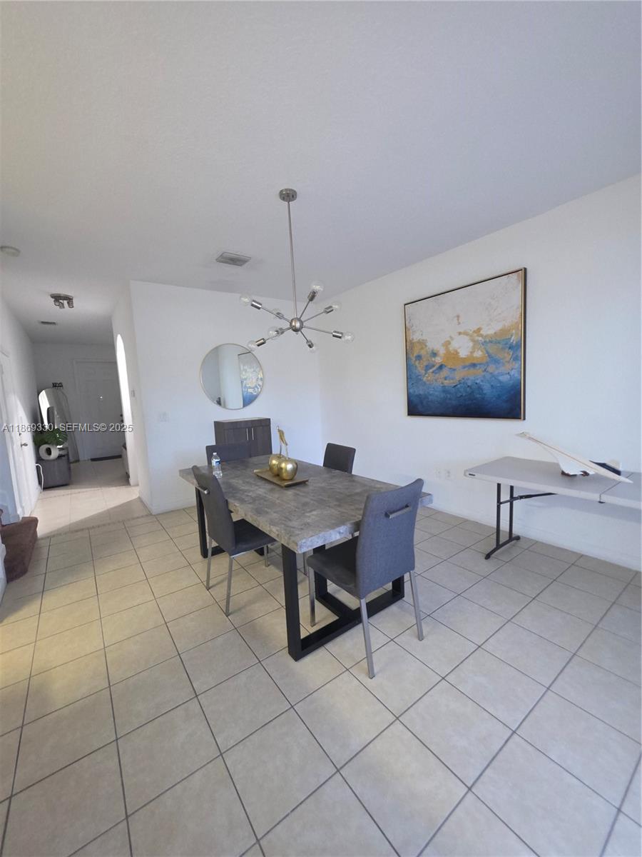 13236 Southwest 128th Street Miami, FL 33186 - Photo 9 of 41 a dining room with furniture and wooden floor