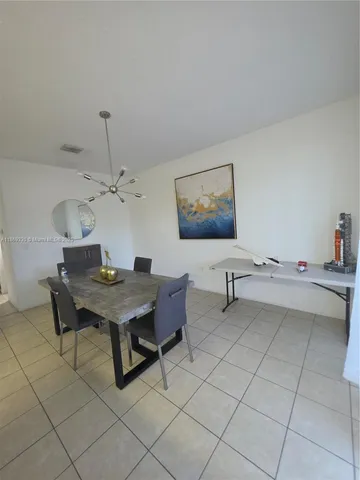 a kitchen with stainless steel appliances a stove a sink and white cabinets