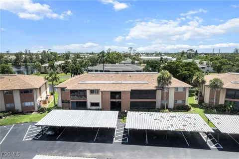 a view of a patio with table and chairs and a yard