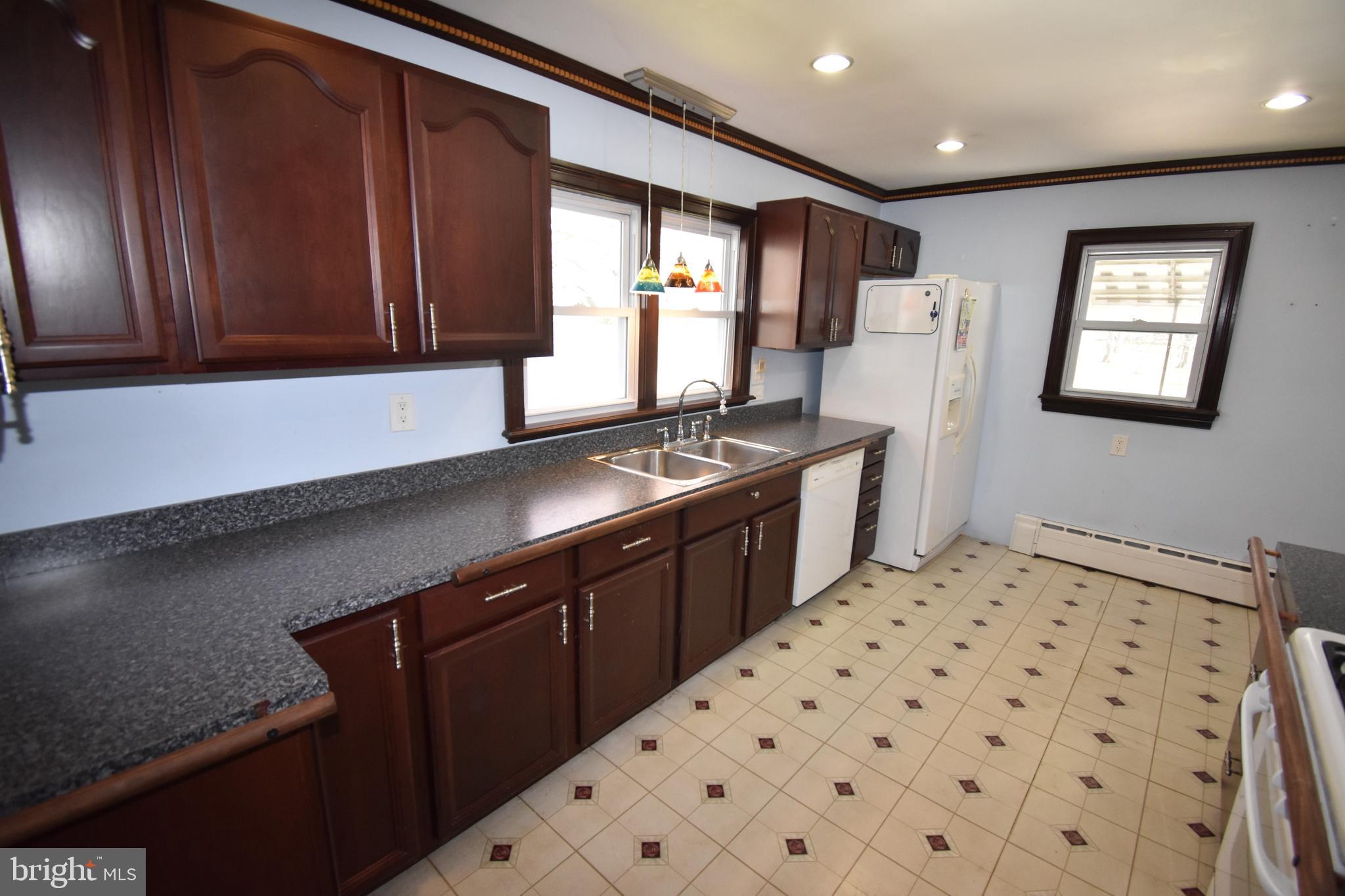 165 West Federal Street Burlington, NJ 08016 - Photo 14 of 27 a kitchen with stainless steel appliances a refrigerator and a stove top oven