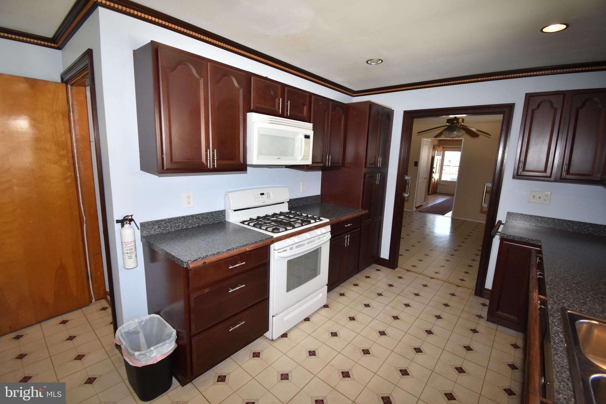 165 West Federal Street Burlington, NJ 08016 - Photo 16 of 27 a kitchen with granite countertop stainless steel appliances a stove sink and microwave