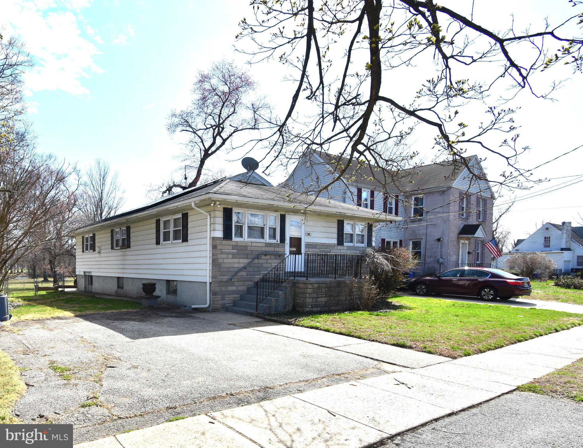 165 West Federal Street Burlington, NJ 08016 - Photo 3 of 27 a front view of a house with a yard and garage