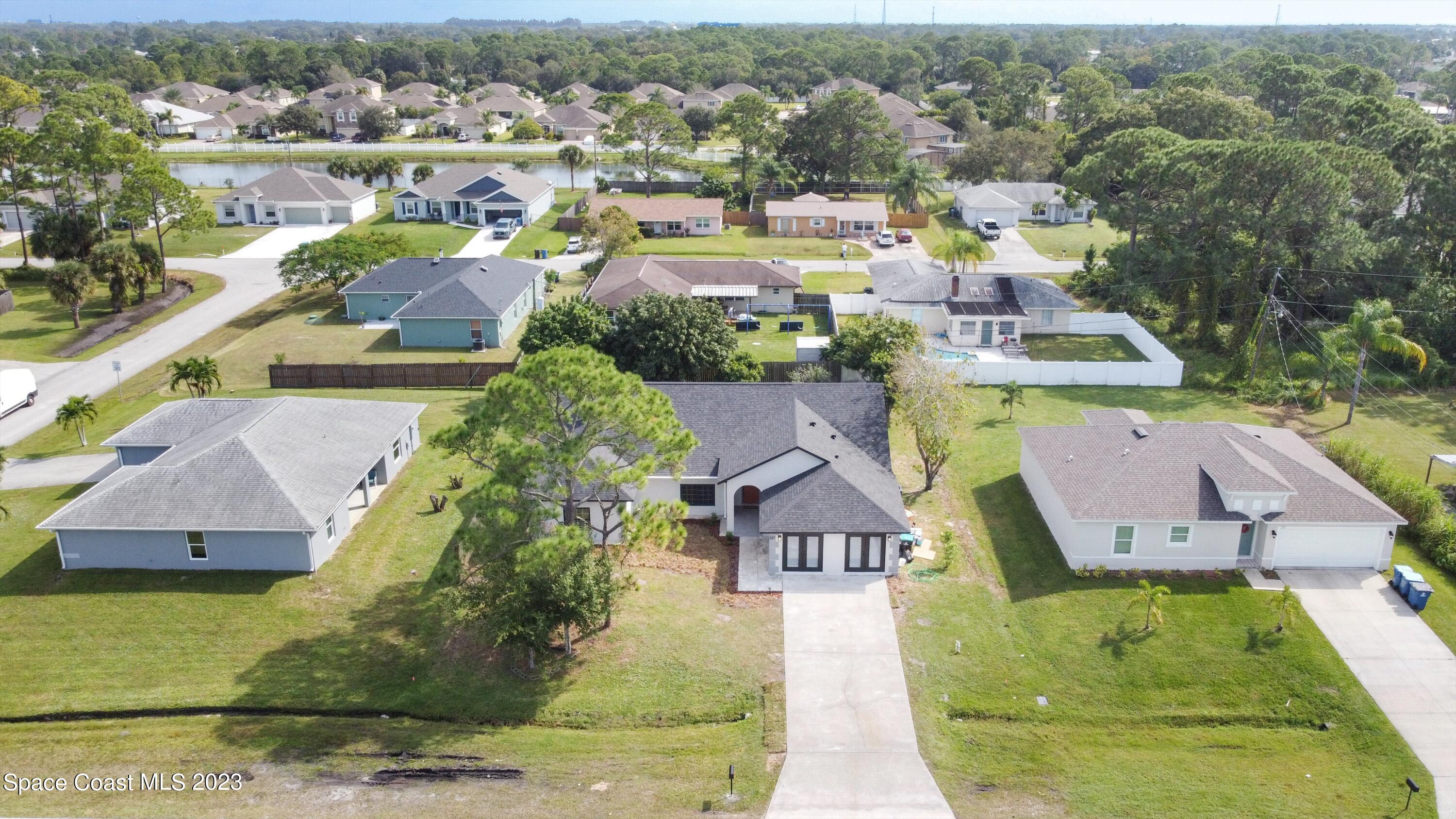 207 Eldron Boulevard Southeast Palm Bay, FL 32909 - Photo 1 of 60 an aerial view of a house with a garden