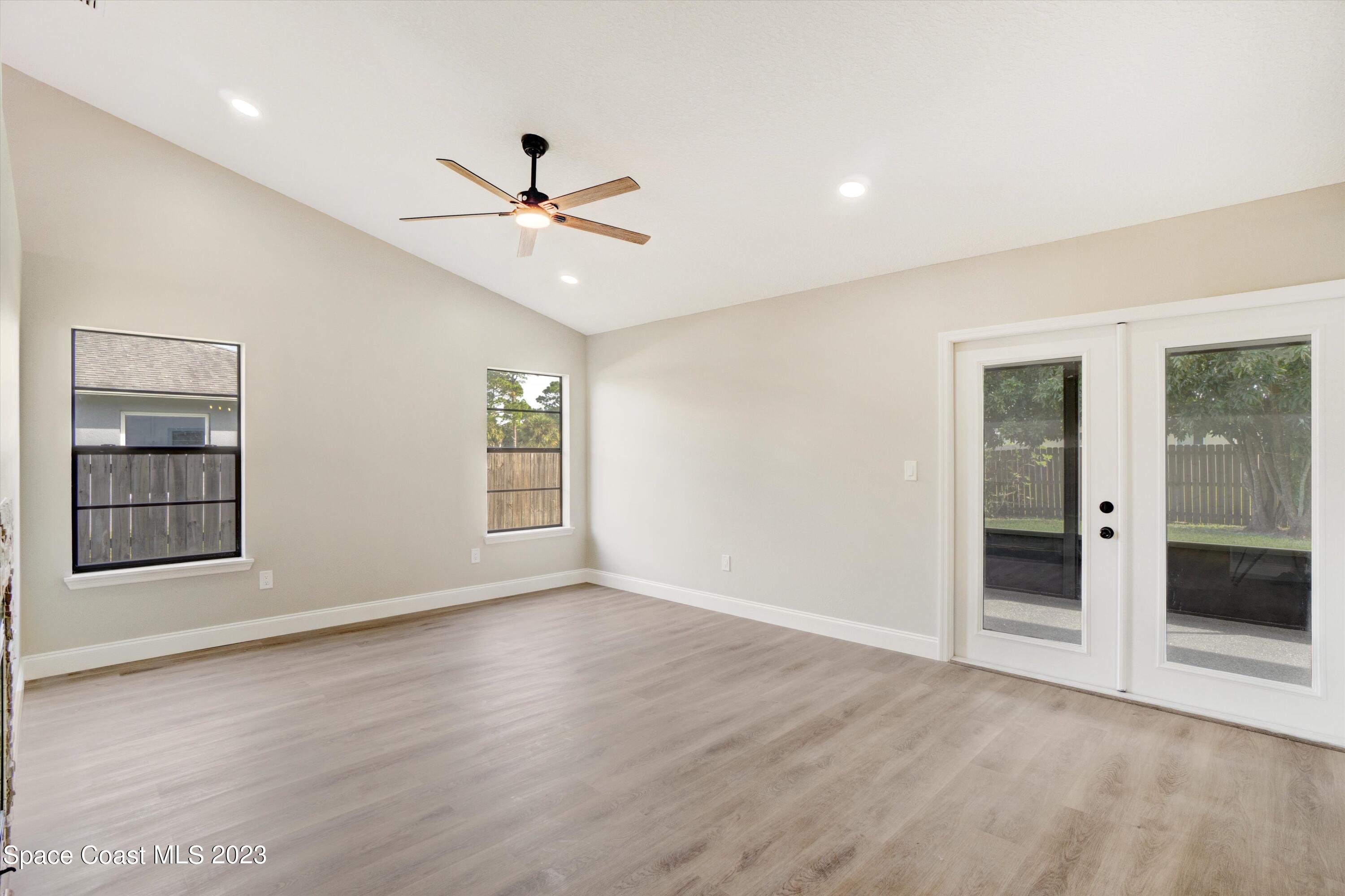 207 Eldron Boulevard Southeast Palm Bay, FL 32909 - Photo 17 of 60 wooden floor in an empty room with a window