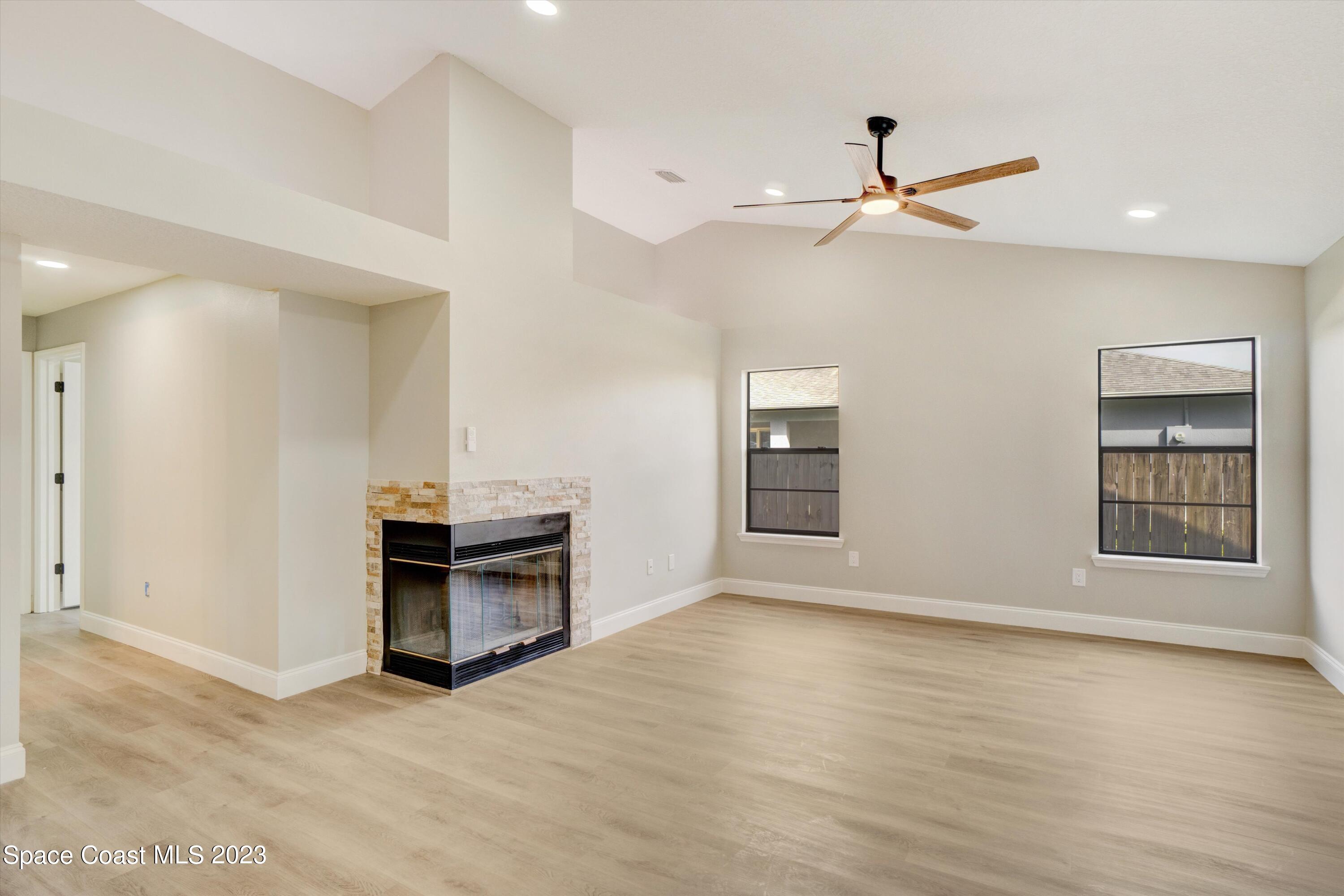 207 Eldron Boulevard Southeast Palm Bay, FL 32909 - Photo 19 of 60 wooden floor in an empty room with a window