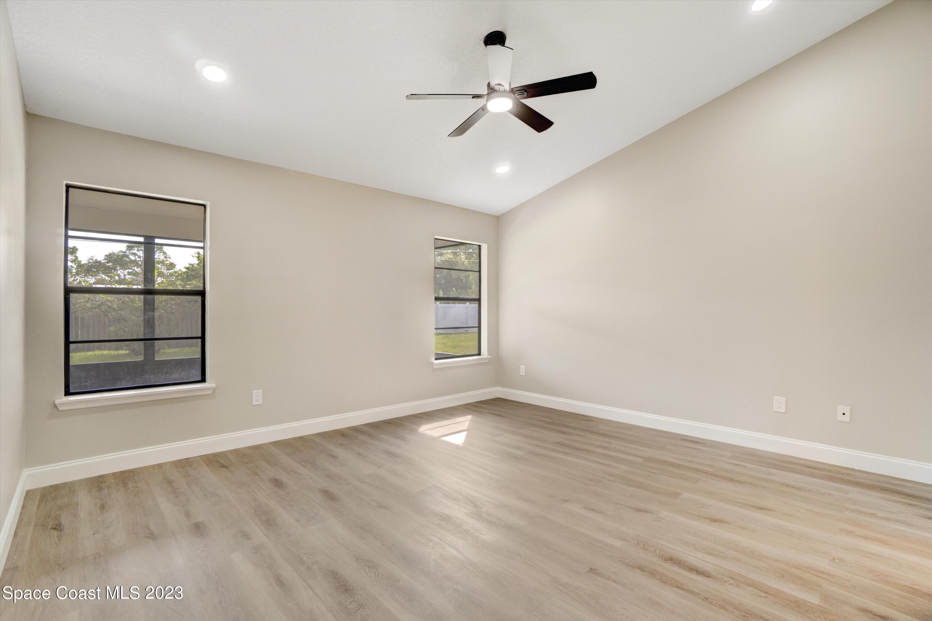 207 Eldron Boulevard Southeast Palm Bay, FL 32909 - Photo 22 of 60 wooden floor in an empty room with a window