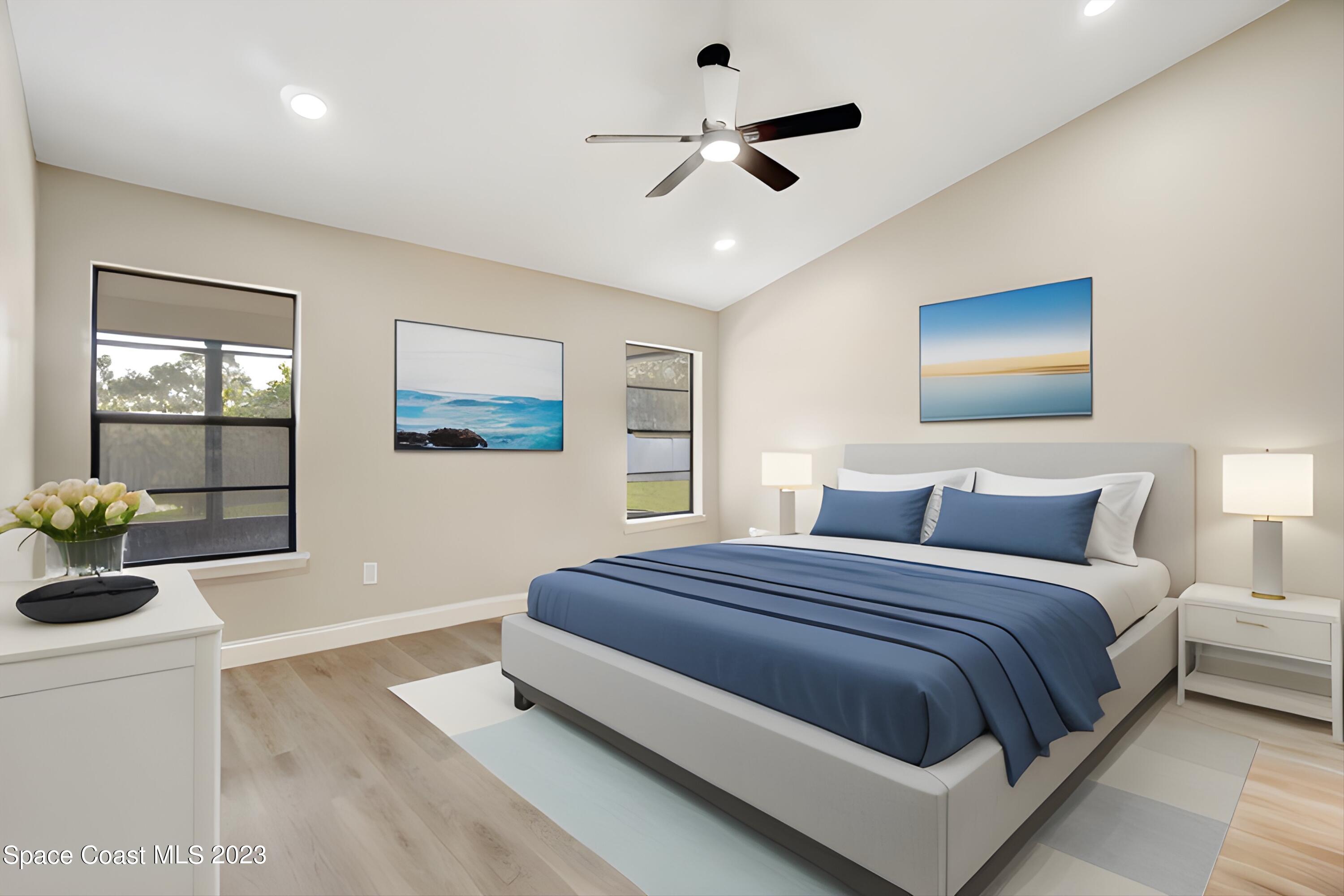 207 Eldron Boulevard Southeast Palm Bay, FL 32909 - Photo 23 of 60 a bedroom with a large bed and a chandelier