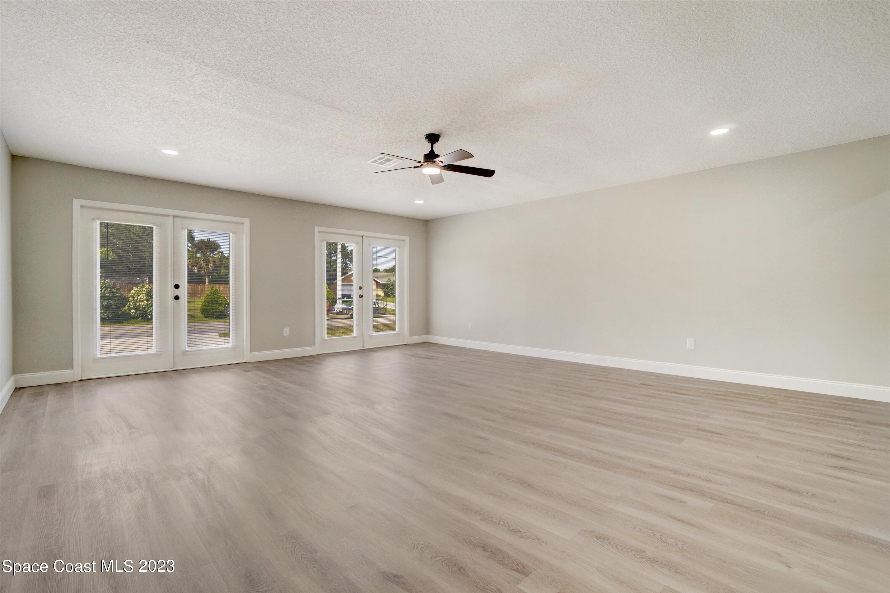207 Eldron Boulevard Southeast Palm Bay, FL 32909 - Photo 34 of 60 wooden floor in an empty room with a window