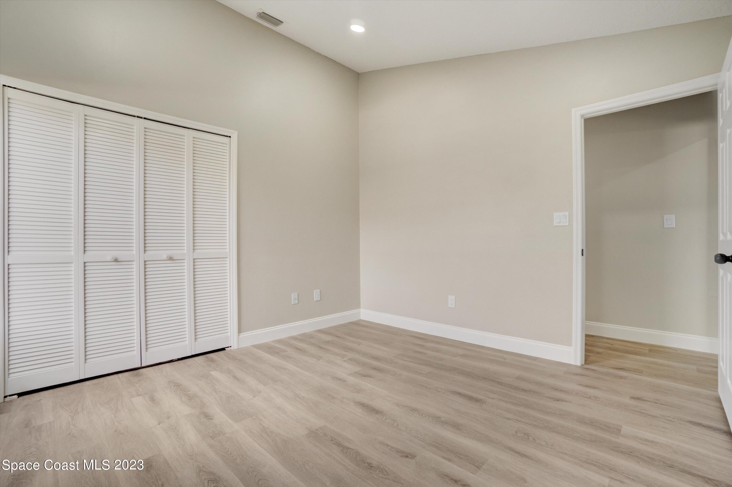 207 Eldron Boulevard Southeast Palm Bay, FL 32909 - Photo 38 of 60 a view of an empty room with wooden floor