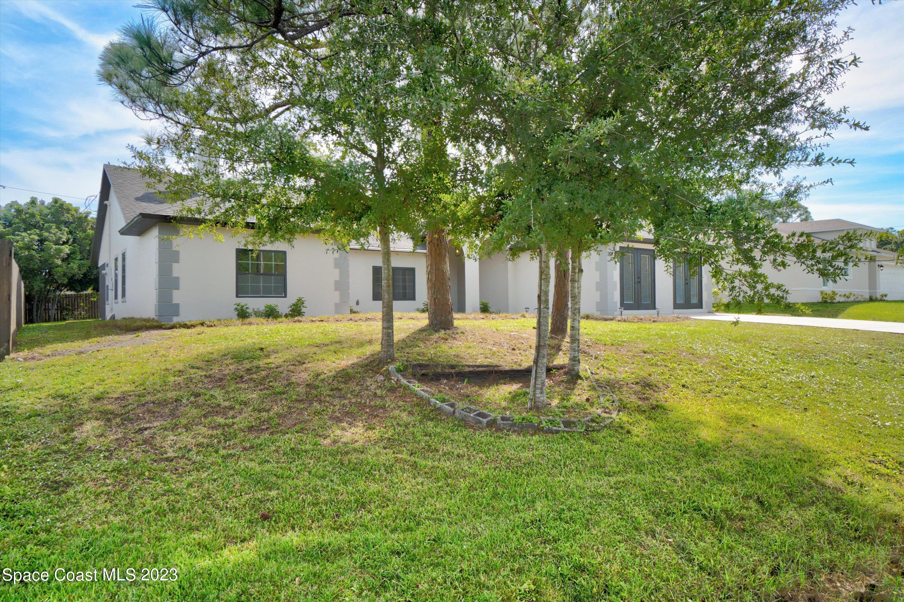207 Eldron Boulevard Southeast Palm Bay, FL 32909 - Photo 4 of 60 a view of a house with yard and tree s